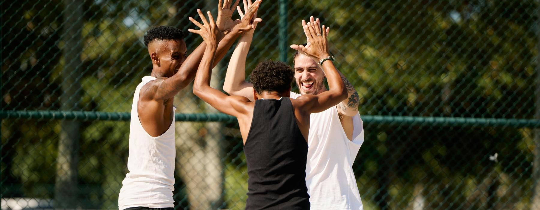 a group of men playing basketball